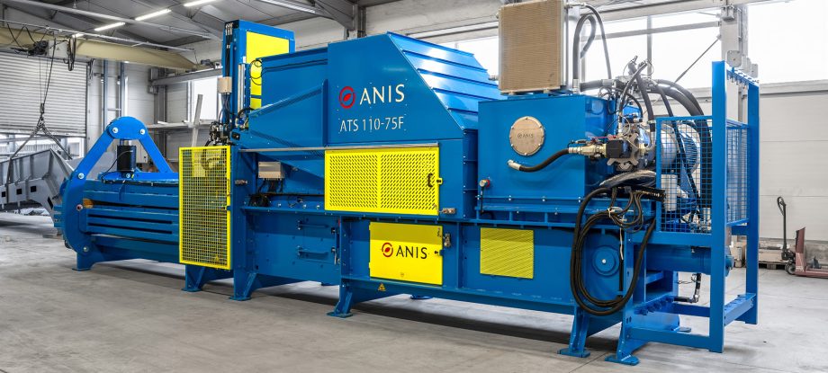 Blue ANIS ATS 110-75F industrial press in a factory with yellow protective guards highlighting essential Baler safety features.