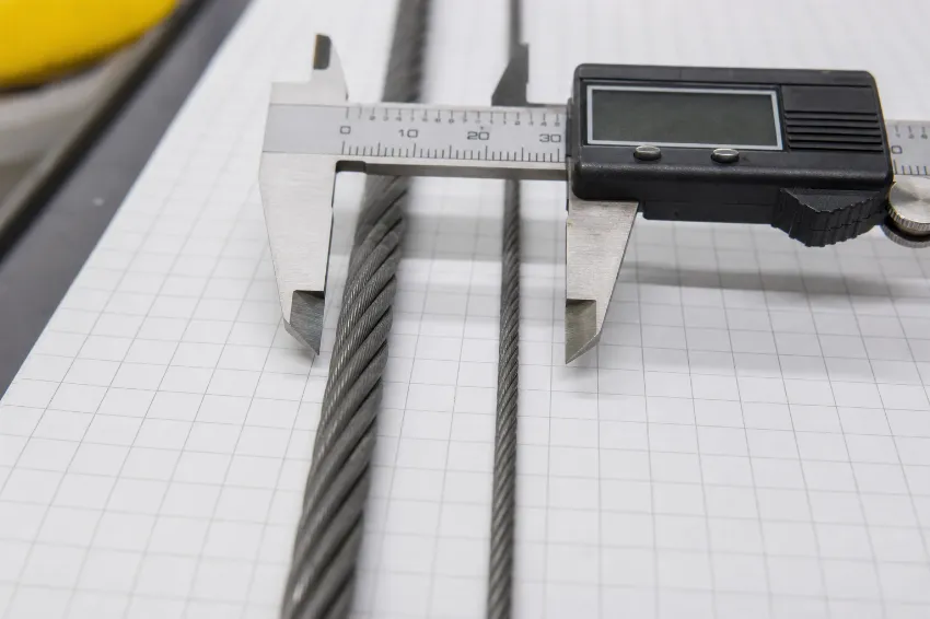 Comparing two baling wire diameters with a digital caliper