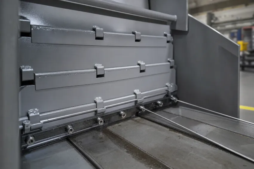 Wire guide and needle slot on a channel baling press